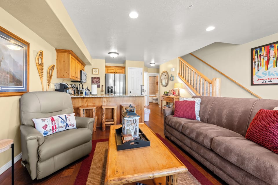 The living room, freshly appointed with new furniture, offers easy access to the outdoor deck.