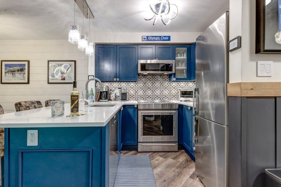 Stone countertop surrounds brand new stainless steel appliances in the kitchen.