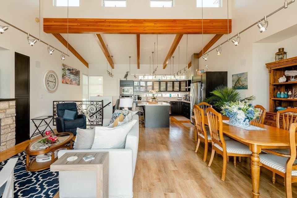 Facing into the upstairs living area from the deck, with kitchen against the back wall. 