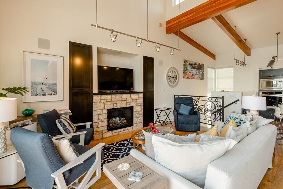 The living room and TV area, over a gas fireplace. There is built in surround sound throughout the entire house (downstairs as well)!