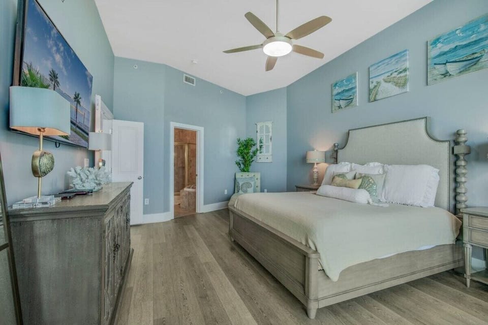 Main bedroom with mounted flat screen TV.