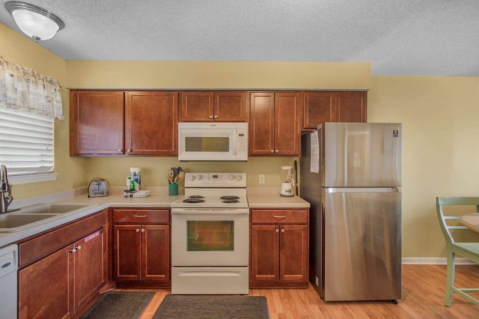 Kitchen is stocked with pots/pans/utensils.