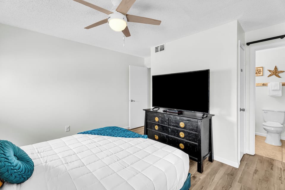 King bedroom with large flat-screen TV