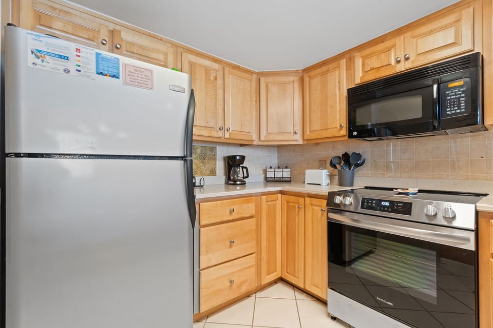 Stocked with pots/pans/utensils