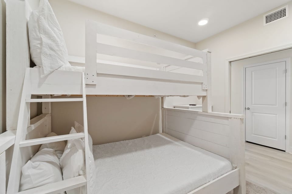 Second bedroom with double-size bunkbed on bottom and twin-size bed on top.