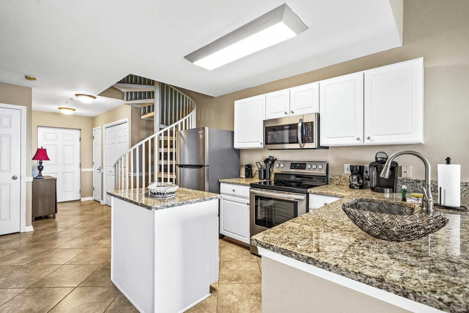 Kitchen & spiral staircase leading to the loft