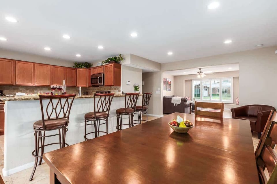 Kitchen area featuring island bar seating and dining table for 6.