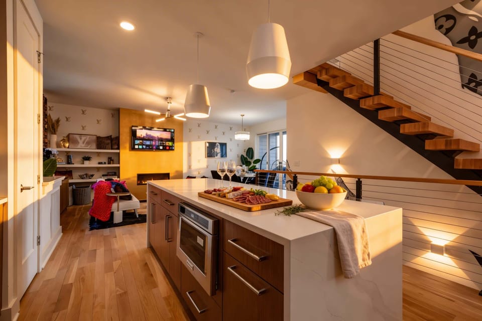 The open kitchen flows into the living room so the cook stays part of the conversation while everyone hangs together