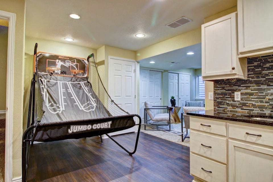 Intense hoops action unfolds in the vibrant game room as players compete with fervor, chasing victory on the hardwood.