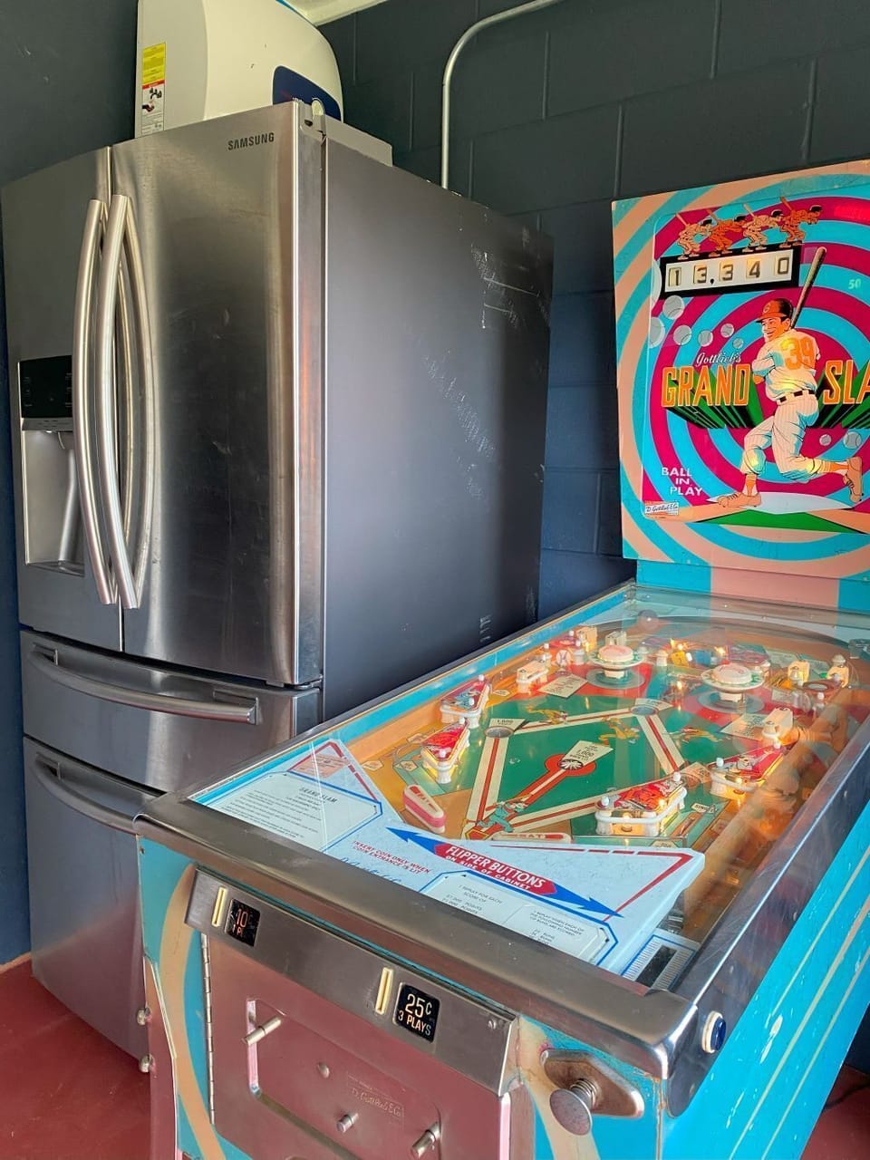 pinball machine and fridge at the Outhouse