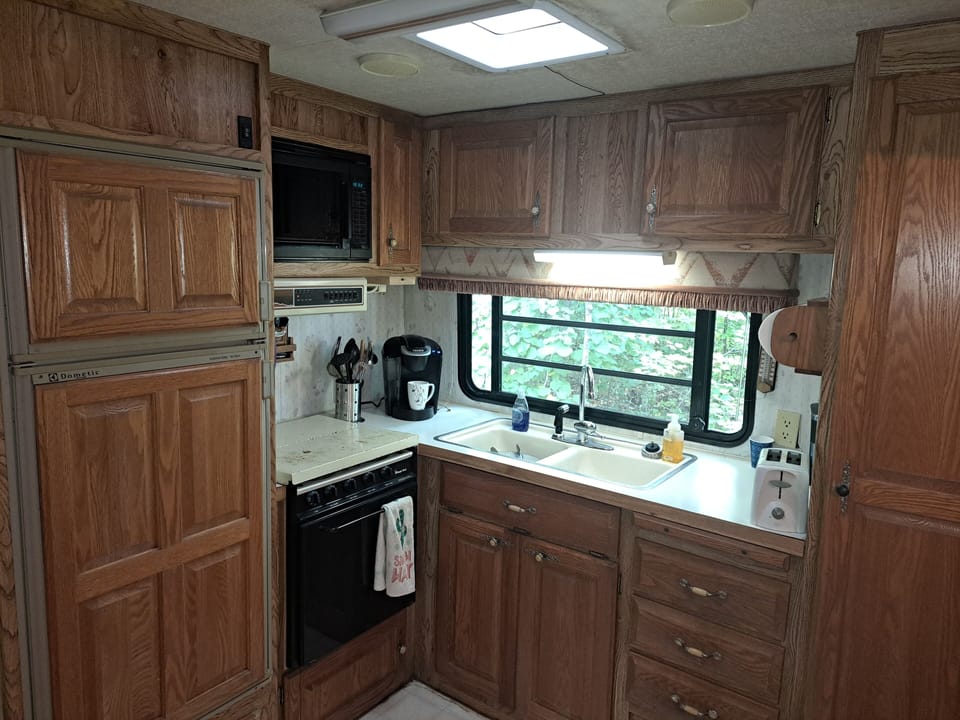kitchen updated with new fridge, range, faucet, coffee maker