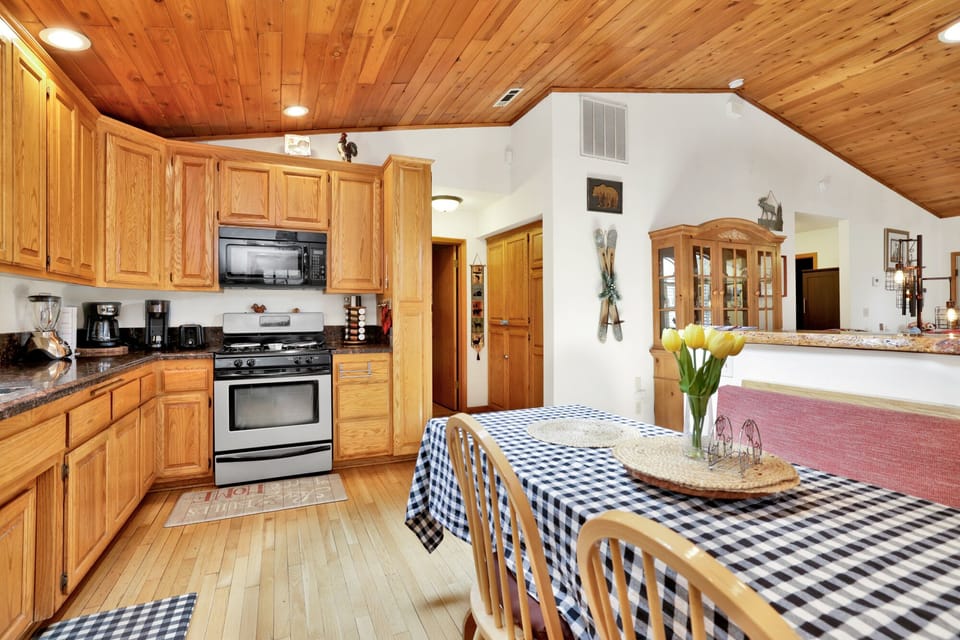 Fully equipped cabin kitchen with ample cabinetry, stove, fridge, and coffee maker—perfect for cooking meals, morning coffee, and feeling right at home on your stay.