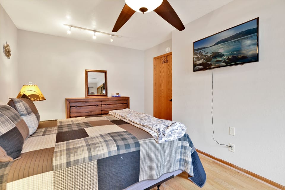 Peaceful cabin bedroom with plush bedding, and beautiful views—ideal for restful nights, cozy mornings, and a relaxing mountain escape.