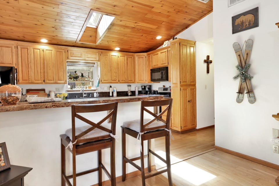 Fully equipped cabin kitchen with ample cabinetry, stove, fridge, and coffee maker—perfect for cooking meals, morning coffee, and feeling right at home on your stay.
