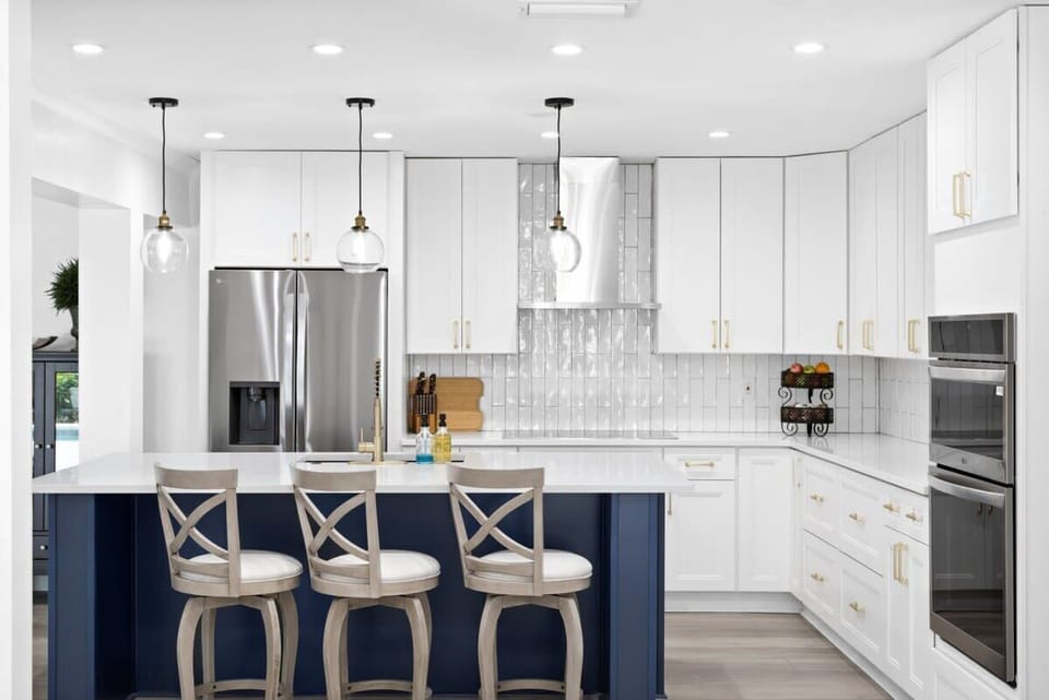 Expansive fully equipped kitchen with breakfast bar seating for up to three