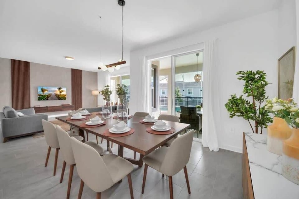 The spacious open-concept dining room has ample seating, making it easy for everyone to enjoy meals together after a day of Florida adventures.