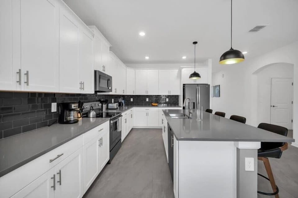 Enjoy the bright open-concept kitchen with stainless steel appliances, plenty of counter space, and a functional layout that keeps everyone connected.