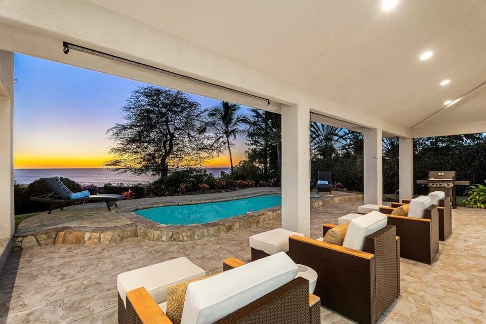 Relax on the chaise lounge with uninterrupted pool views and garden ambiance under the Hawaiian sky.