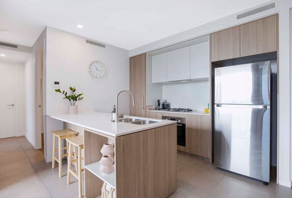 Full gourmet kitchen overlooks the living area with a stove, oven, refrigerator.