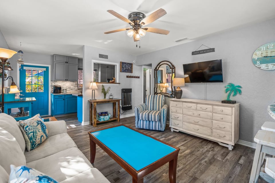 The living room has a queen size sleeper sofa and dresser for extra storage.