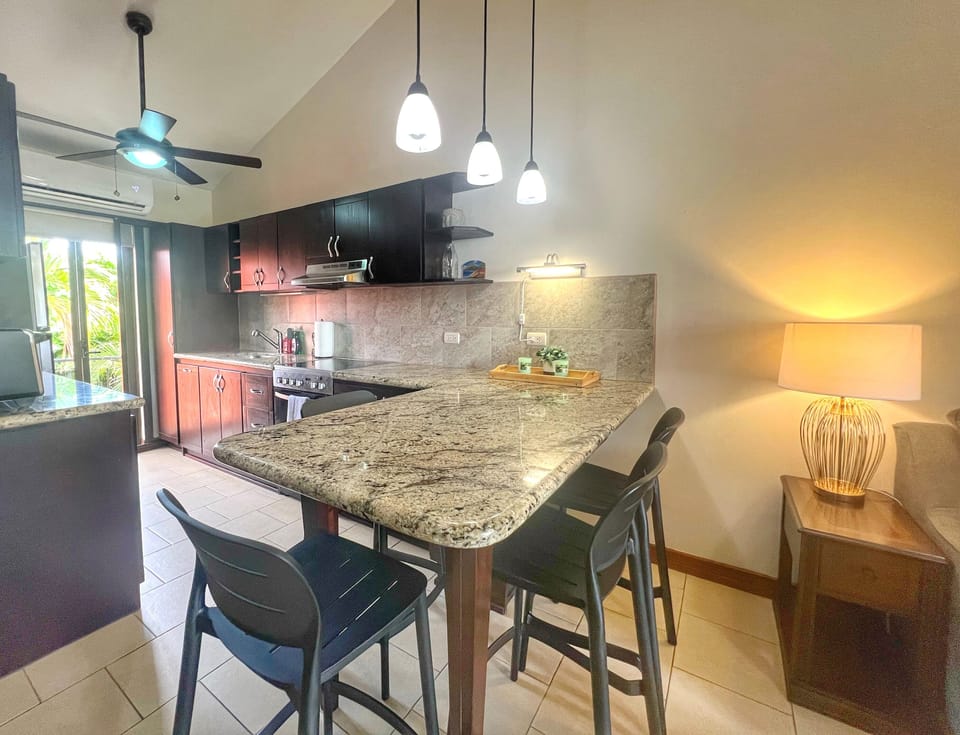 The dine-in kitchen has comfortable chairs (new in 2025) - a great place for dining, working or playing games after a day at the pool!