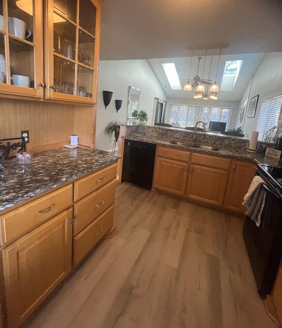 SPACIOUS  FLOOR PLLAN:   Open Kitchen, and seating at granite bar  to dining table, extending  into the living space with sky lights, and high ceilings