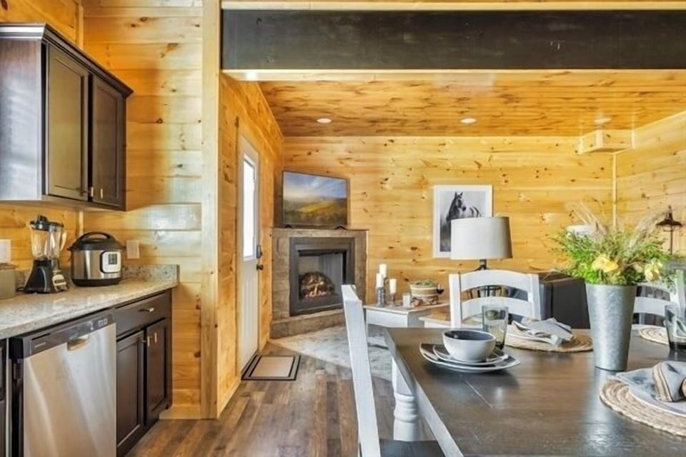 Indulge your inner chef in this kitchen, featuring state-of-the-art appliances, an expansive dining table, and a gallery of tasteful artwork.