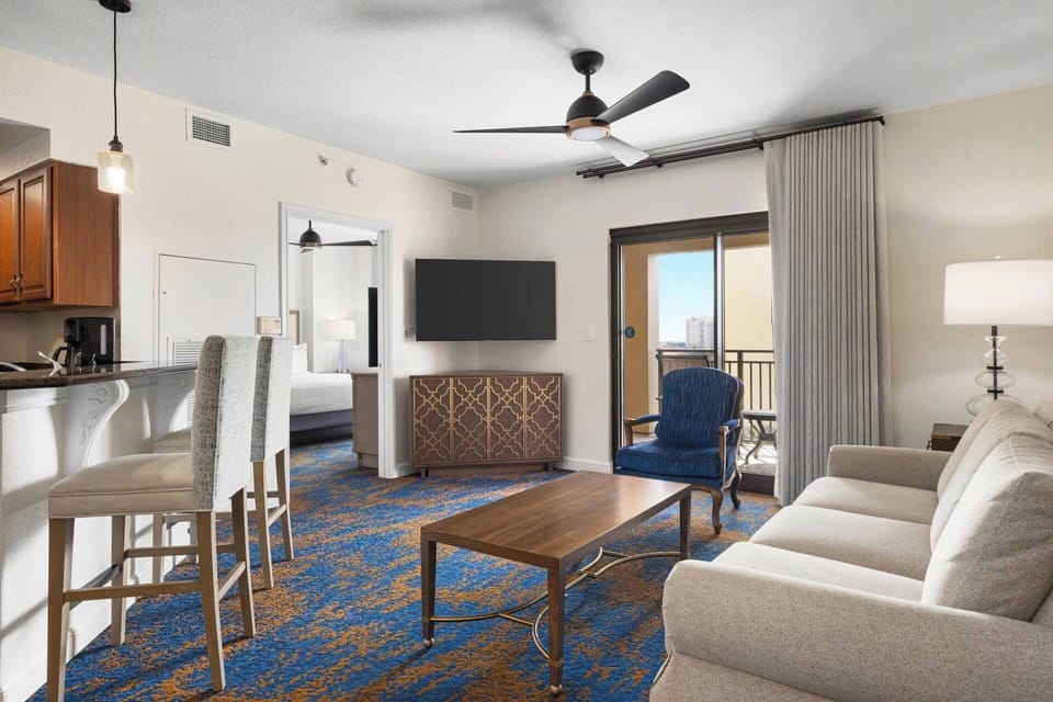 Living room features a sleeper sofa for two and a flat screen TV.