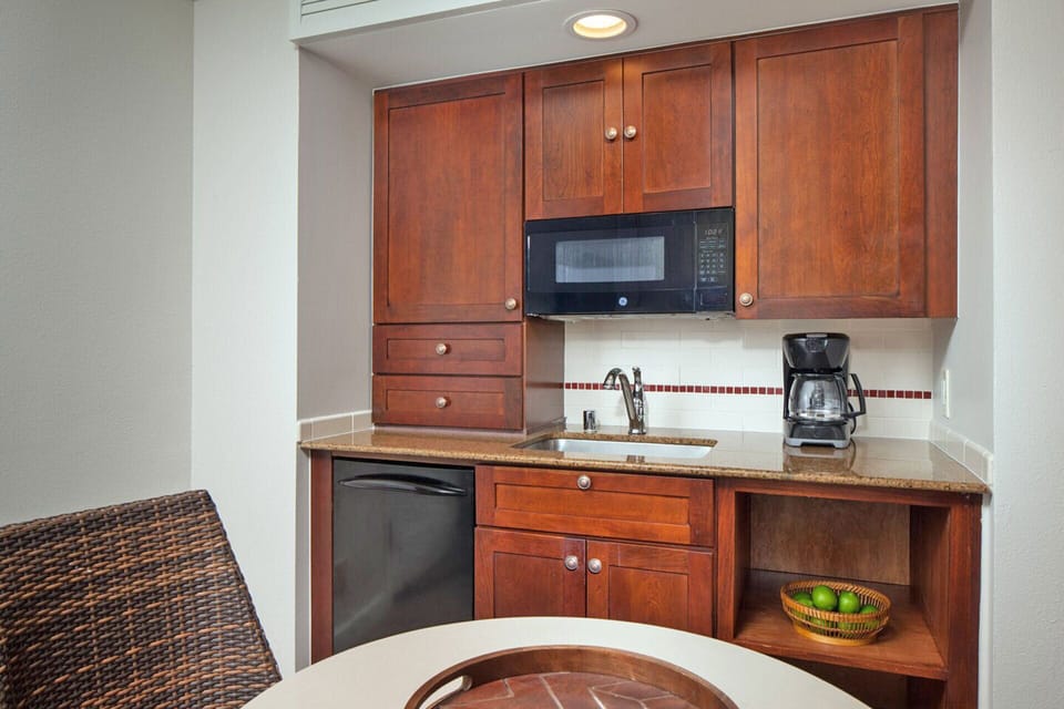 The unit features a kitchenette and dining table.