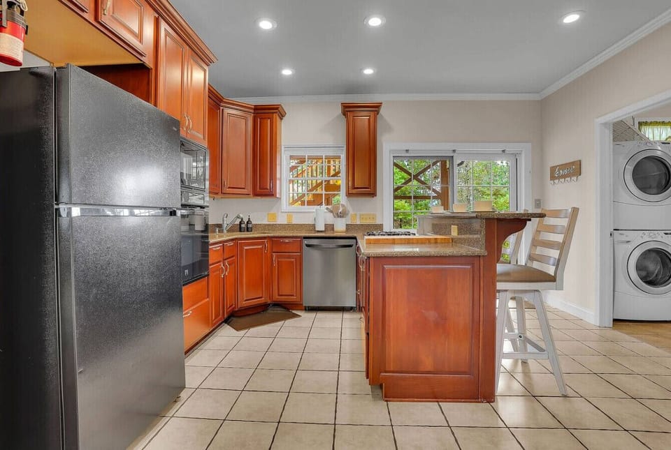 Fully Stocked Kitchen with direct access to the back patio.