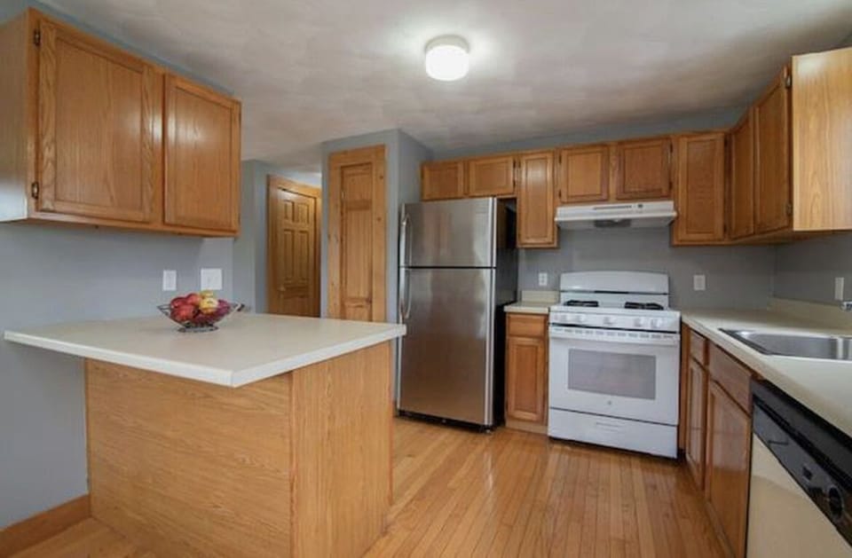 Kitchen complete with microwave, dish washer, coffee maker, blender, air fryer.