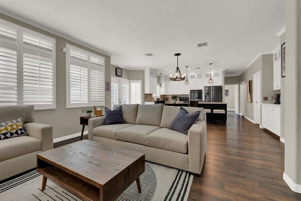 Relax in a generously sized and sunlit living room that seamlessly flows into a well-equipped kitchen.