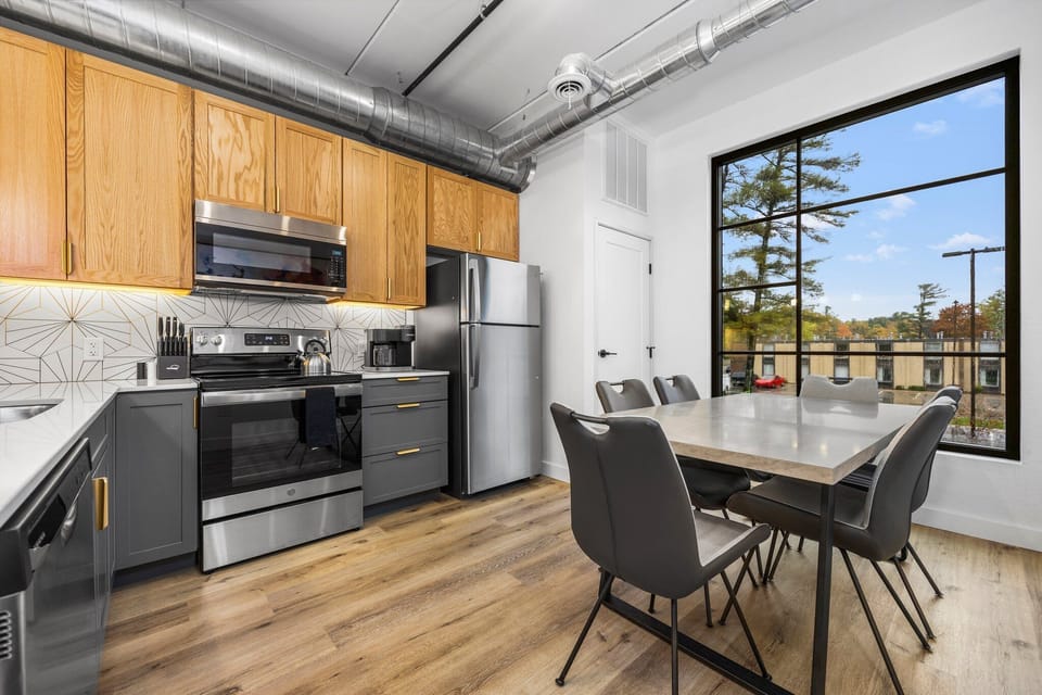 Start your day in this modern kitchen, brewing fresh coffee as the city wakes up beyond the windows a peaceful rhythm that feels like home.