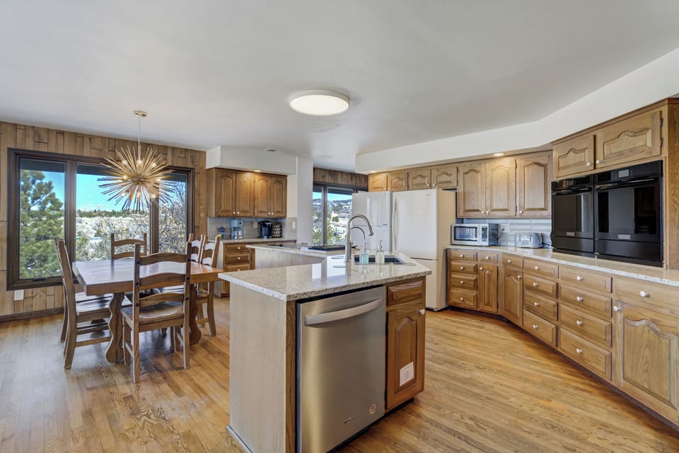 Full kitchen with three ovens, granite countertops, and huge single bowl sink.