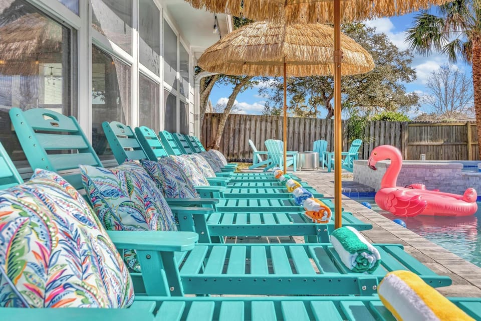 Resort style backyard - pool & spa, lounge chairs, tiki umbrellas, pool basketball, fire pit, bbq grill, surf board outdoor shower, detached bunk house, outdoor table seating, outdoor sectional.
