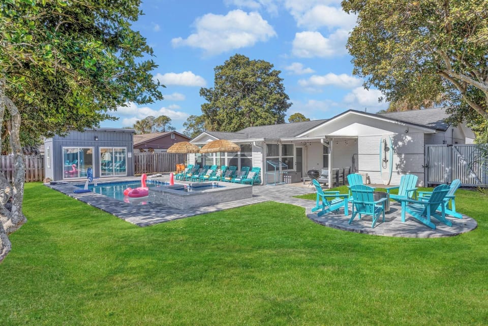 Resort style backyard - pool & spa, lounge chairs, tiki umbrellas, pool basketball, fire pit, bbq grill, surf board outdoor shower, detached bunk house, outdoor table seating, outdoor sectional.