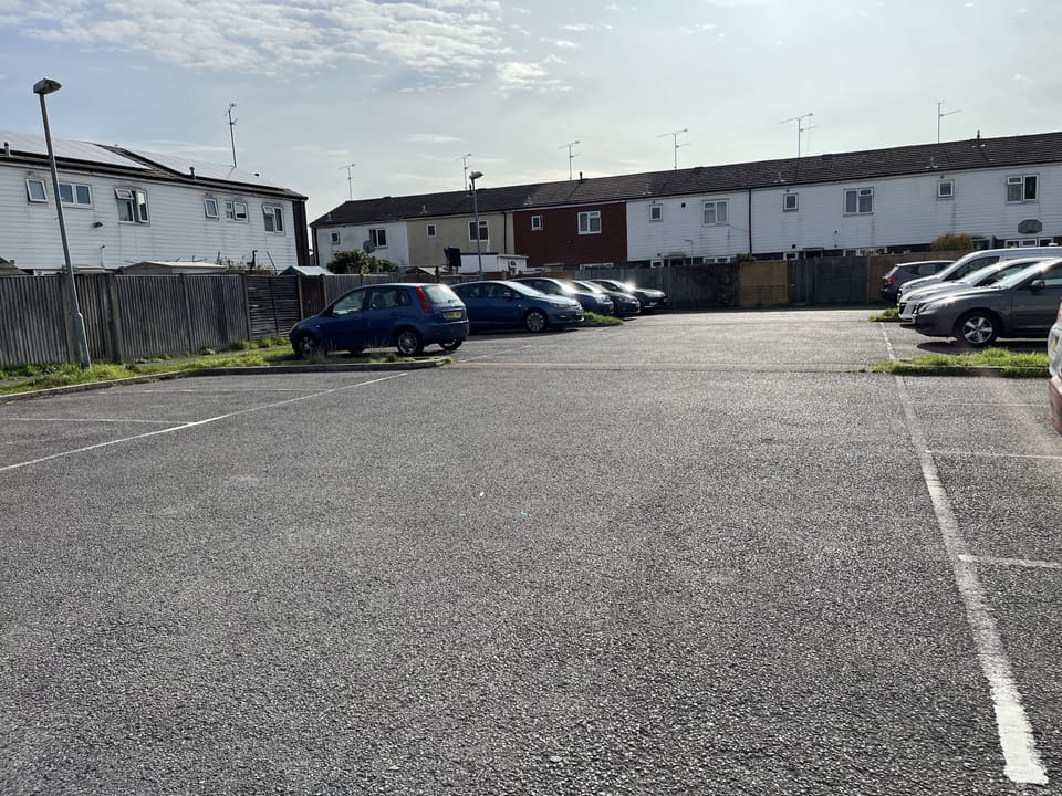 Free communal parking at back of a Property. It is yellow house second from Left