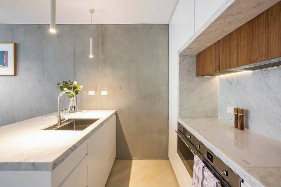 Homemade meals are made easy in the state-of-the-art entertainer's kitchen with Smeg oven, microwave/grill, and induction cooktop.