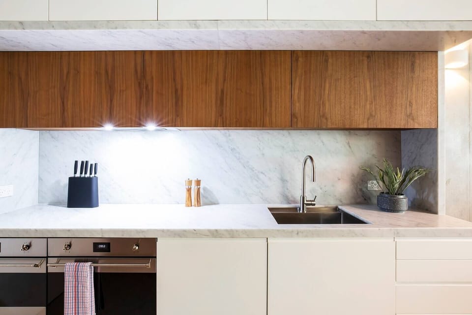 With all the essentials included, eat in using the fully-equipped kitchen that combines marbled stone bench tops and splash backs with impressive timber furnishings.