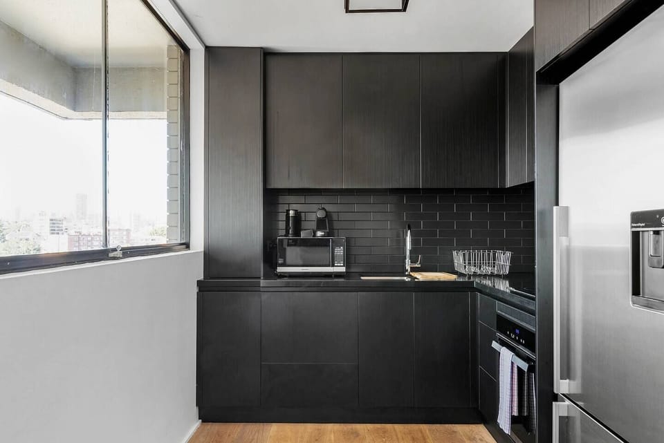 The kitchen is fitted with state-of-the-art appliances including an induction stovetop and Nespresso coffee maker. 