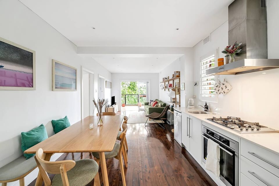 Open-plan living takes you from the kitchen and dining area to the living room and out onto the tranquil balcony