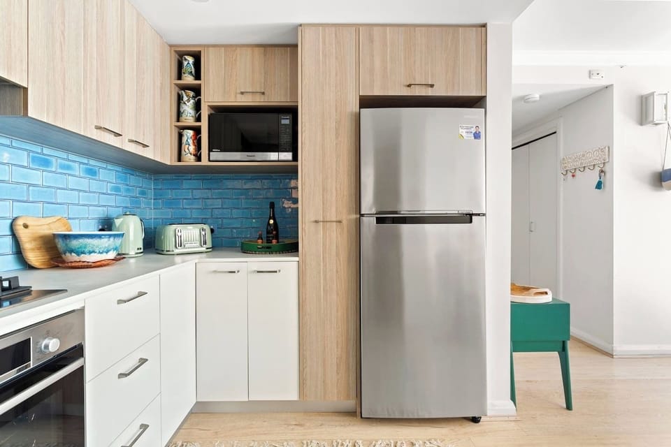 The kitchen has ample cabinetry stocked with cooking basics, pots, pans, cutlery and dishes so you can ensure meals at home are quick and easy.