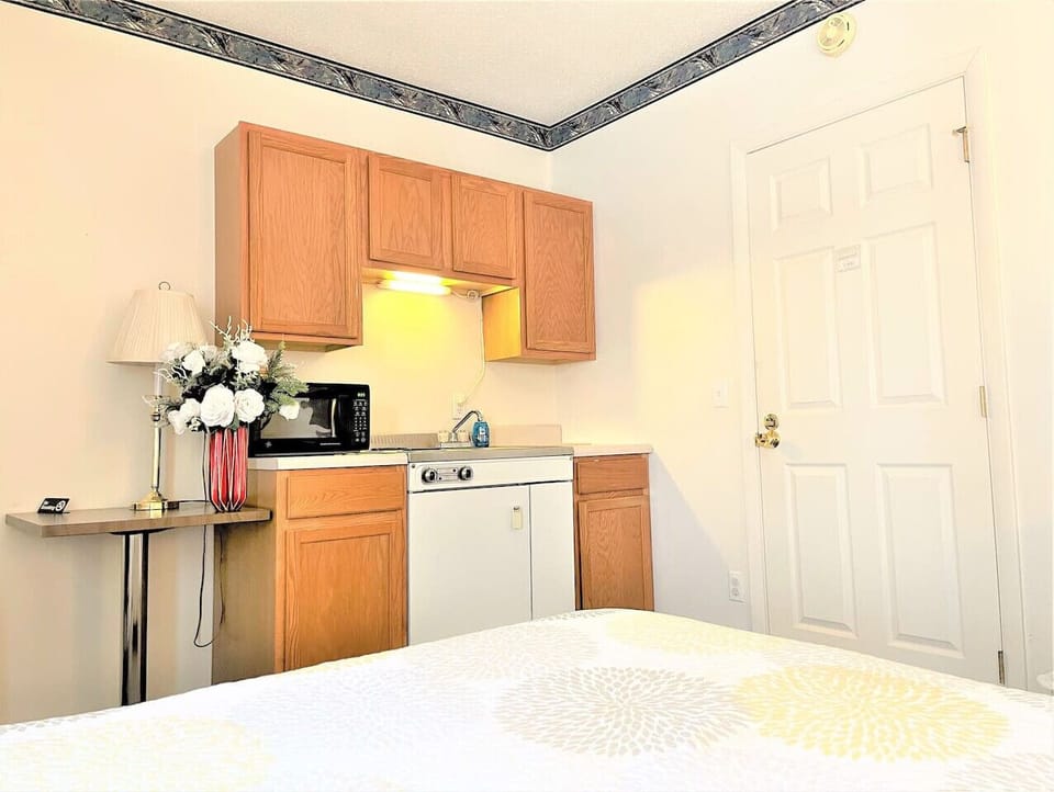 Kitchenette includes sink, range, microwave, mini-fridge plus cookware and flatware.