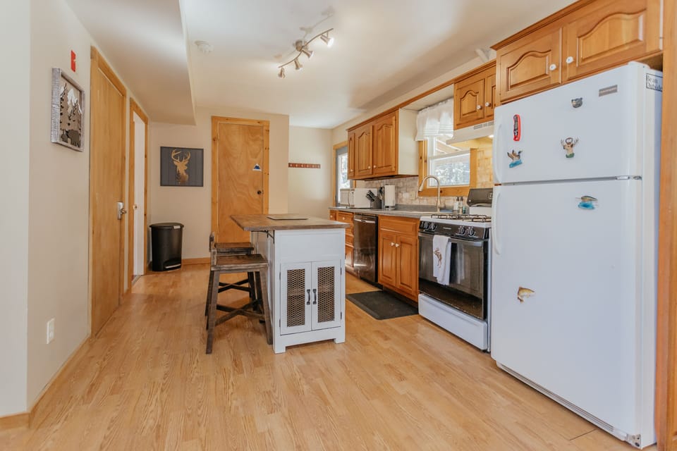 Beautiful sunny kitchen, fully stocked with plates, utensils, pots, pans, etc.