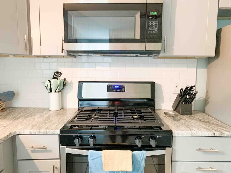 In the kitchen - gas stove, microwave, cooking utensils, basic pots and pans, cookie sheets, measuring cups, silverware, kids dishes/silverware, knife set, cutting boards, coffee mugs, glasses, plates, bowls, mixing bowls are included.