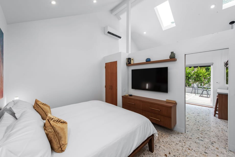 Bedroom with TV, drawers and closet