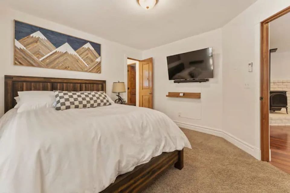 Queen size bed with 50" TV in bedroom #4 down stairs.