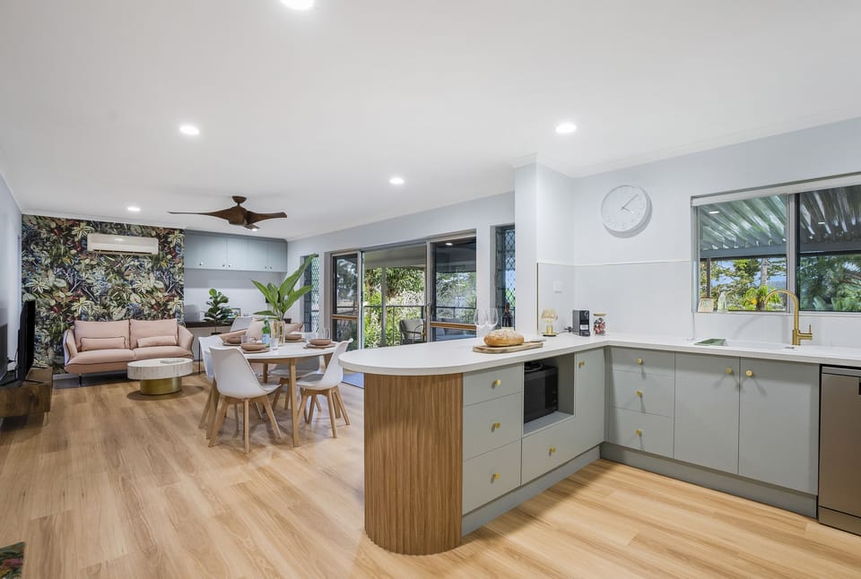 Open plan, living, dining and kitchen area double doors opening onto deck