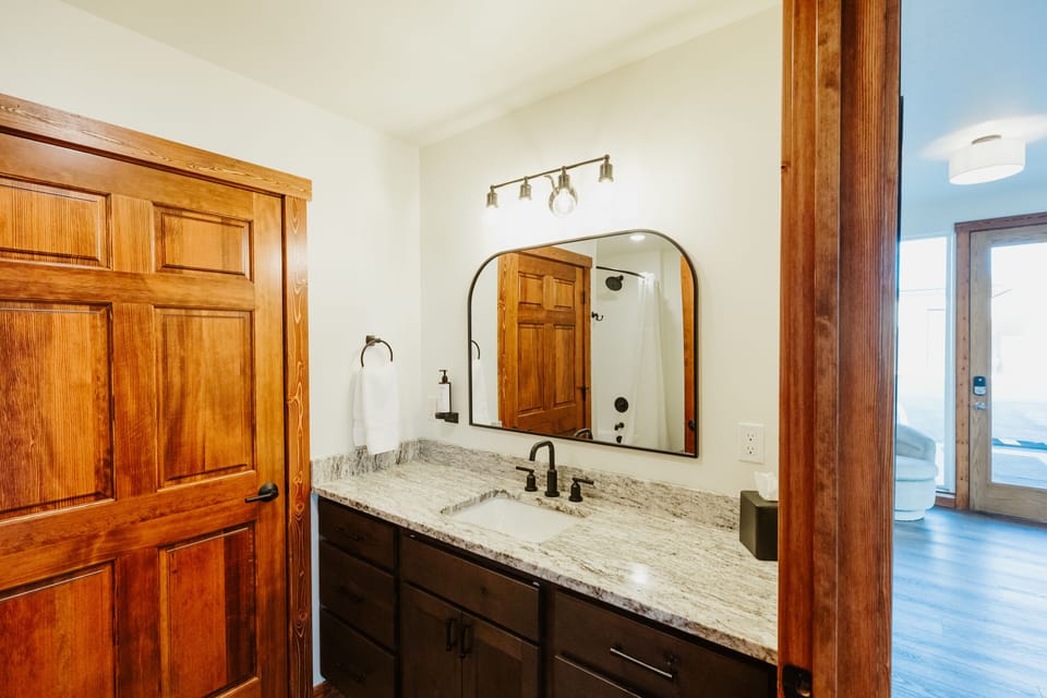 [Bathroom] Our private bathroom is bright and has plenty of counter space for getting ready.