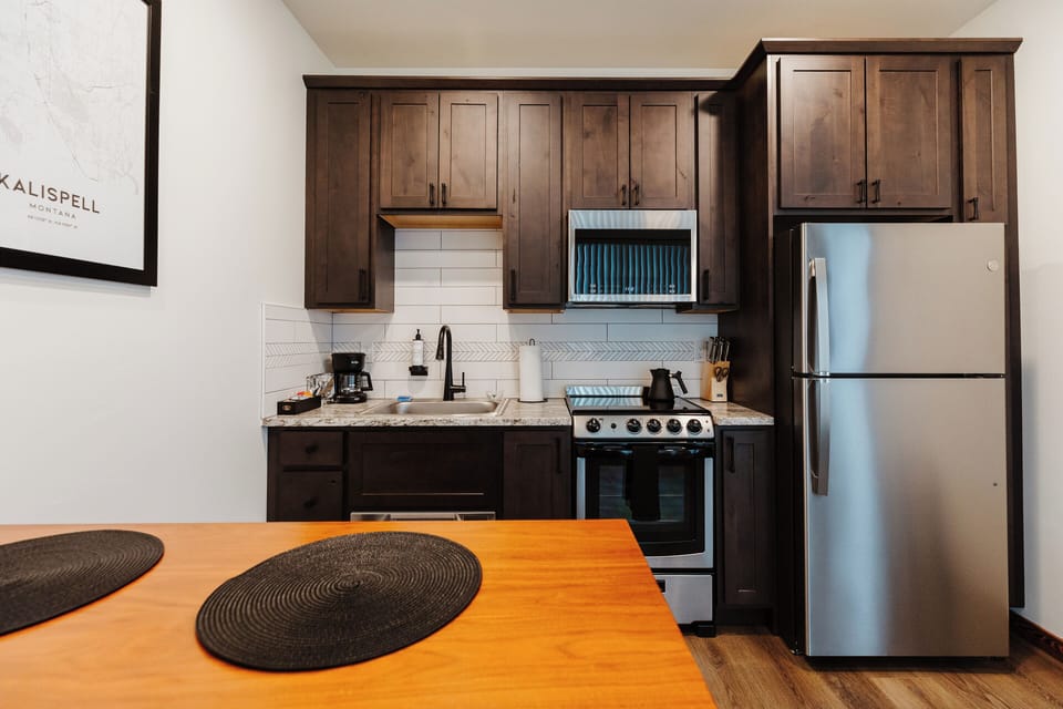 [Kitchen] Our kitchen is equipped with everything that is needed to make a full dinner - including a range with an oven, a full-size fridge, and a dishwasher drawer.